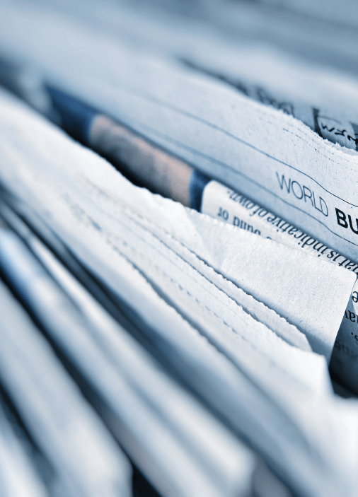 The top of pages from a newspaper stacked together